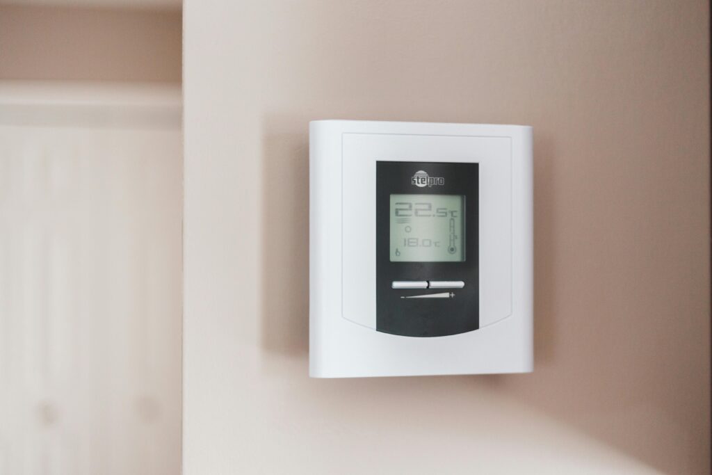 Start thermostat installed on a beige wall