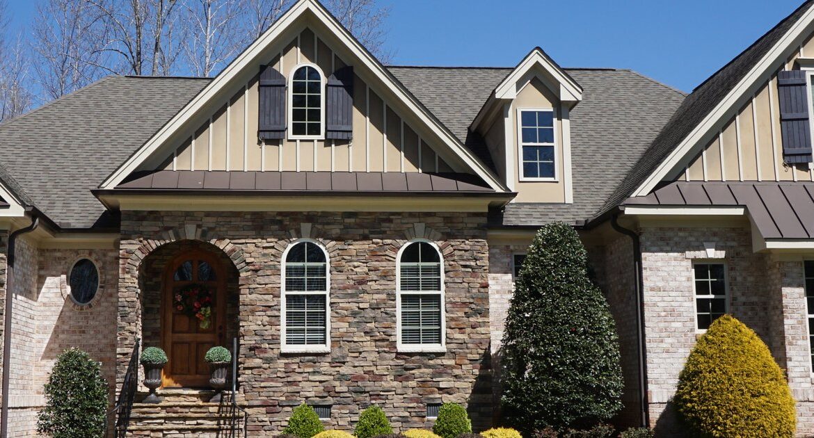 Brick suburban home with a stone-accent facade and tidy front yard
